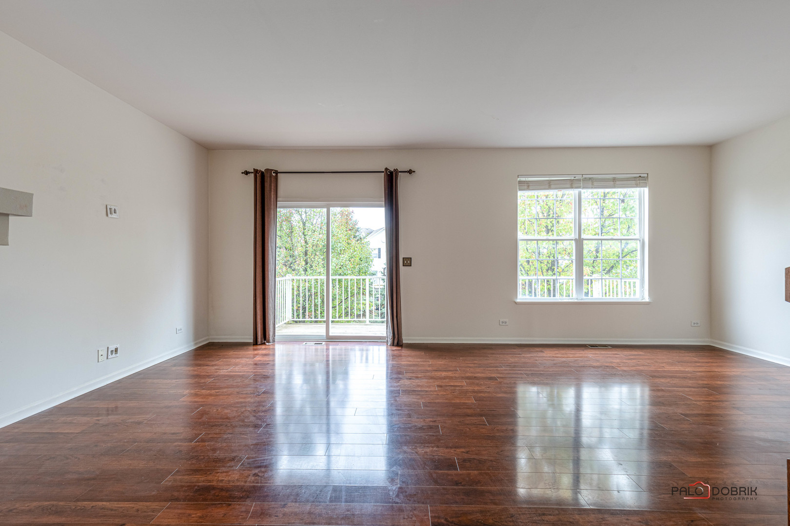 260 Comstock Drive, Unit 260 Elgin, IL 60124 - Photo 9 of 30 a view of an empty room with wooden floor and a window