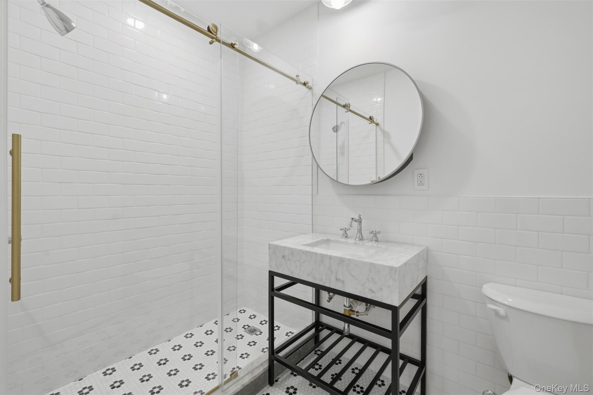 207 Main Street, Unit 3 Beacon, NY 12508 - Photo 16 of 23 a bathroom with a sink a toilet and a mirror
