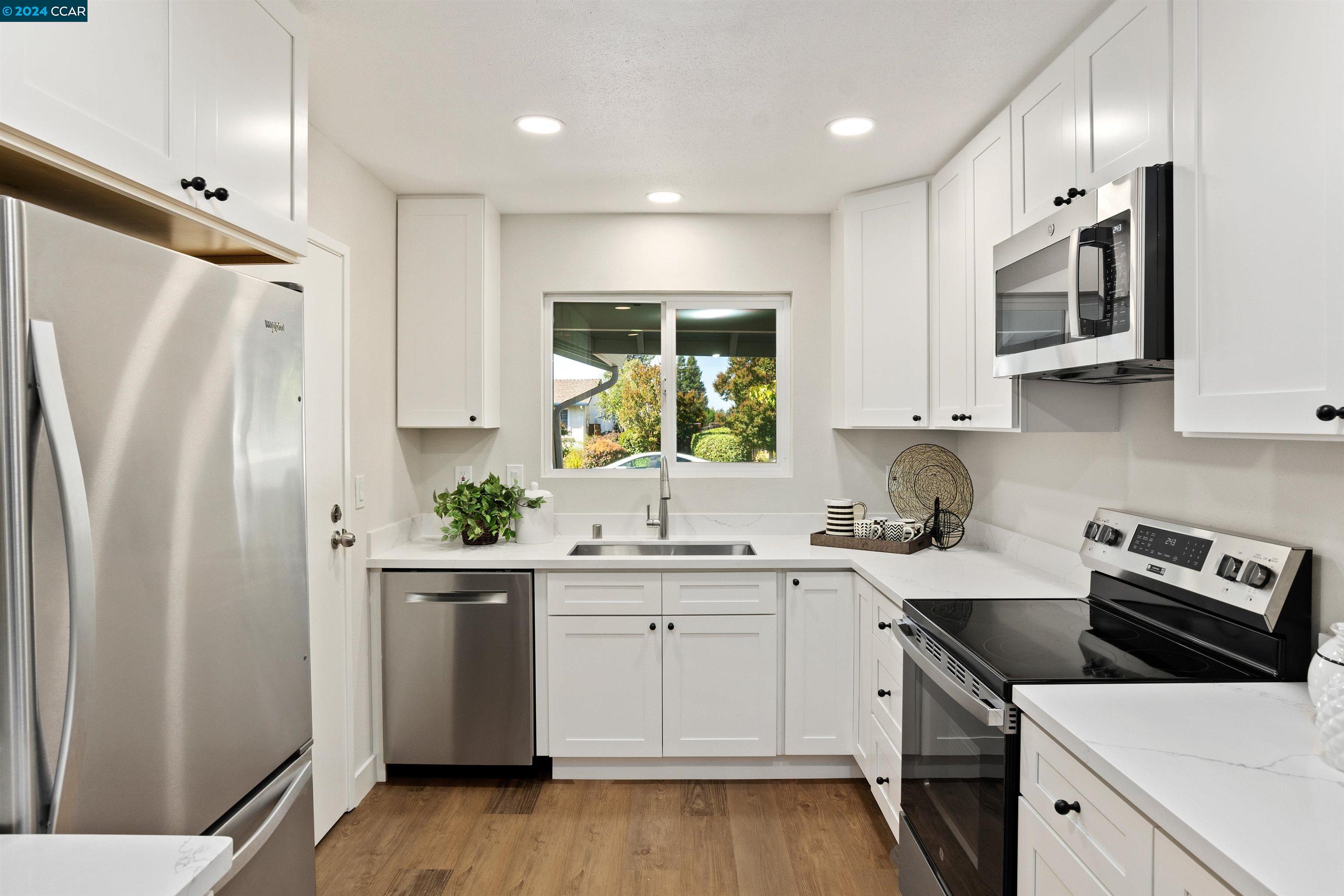 Pine Valley Road San Ramon, CA 94583 - Photo 14 of 34 a kitchen with white cabinets and white appliances