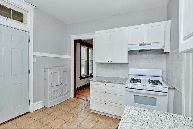 5436 West Ferdinand Street, Unit 3E Chicago, IL 60644 - Photo 12 of 16 a kitchen with white cabinets and appliances