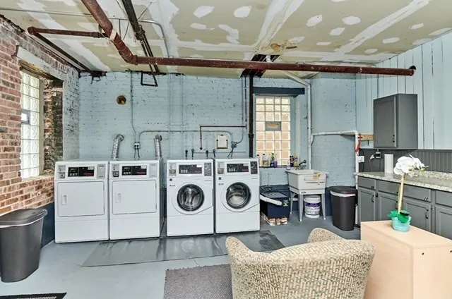 a kitchen with a stove a refrigerator and a table