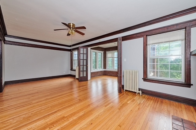 5436 West Ferdinand Street, Unit 3E Chicago, IL 60644 - Photo 3 of 16 a view of empty room with wooden floor and fan