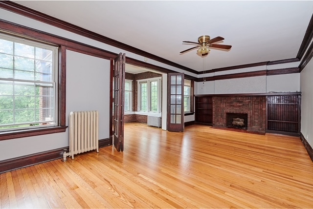 5436 West Ferdinand Street, Unit 3E Chicago, IL 60644 - Photo 4 of 16 a view of a livingroom with wooden floor and a ceiling fan