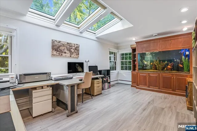 a view of a workspace with furniture and a kitchen