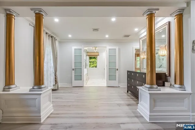 a view of an entryway with wooden floor and windows