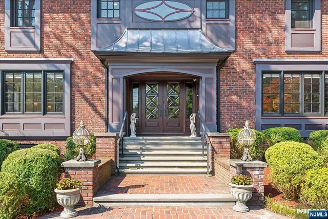 a front view of a house with a garden