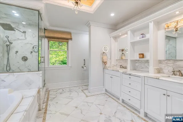 a bathroom with a granite countertop sink mirror and shower