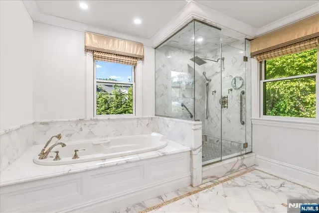 a bathroom with a bathtub and a shower