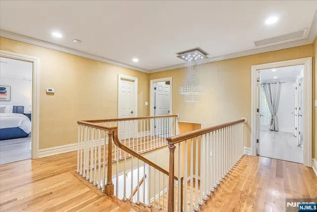 a view of hallway with wooden floor and stairs