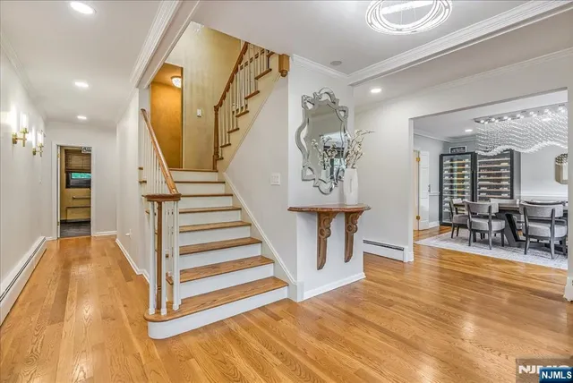 a view of entryway and hall with wooden floor