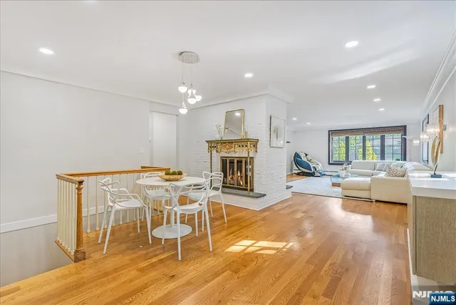 a view of a dining room with furniture wooden floor and a fireplace