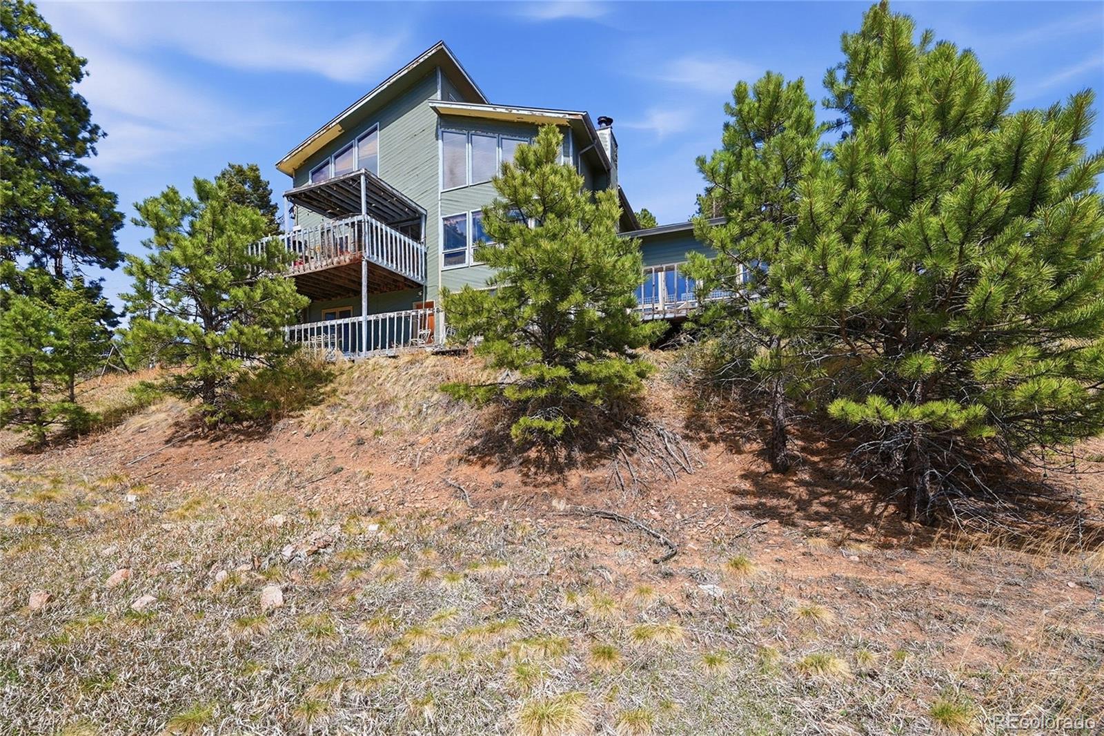 13108 Elsie Road Conifer, CO 80433 - Photo 11 of 49 a view of a house with a yard and plants