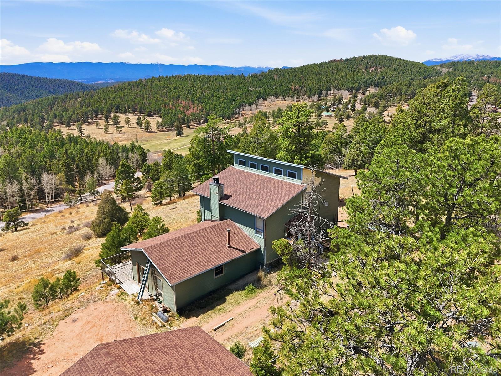13108 Elsie Road Conifer, CO 80433 - Photo 14 of 49 a view of a terrace with a garden and trees