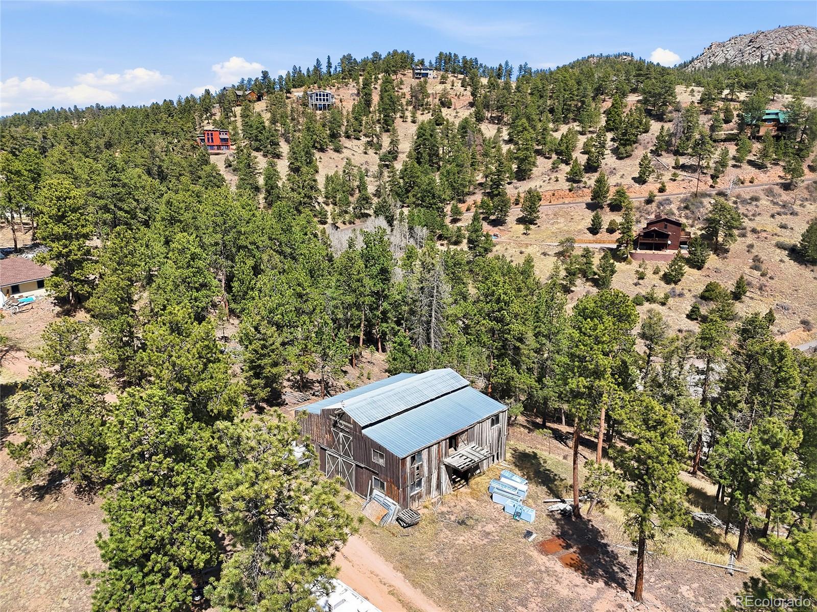 13108 Elsie Road Conifer, CO 80433 - Photo 15 of 49 an aerial view of a house with a yard swimming pool and mountain view