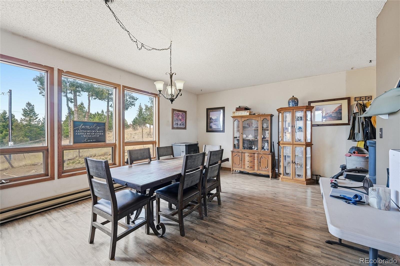 13108 Elsie Road Conifer, CO 80433 - Photo 5 of 49 a view of a dining room with furniture window and wooden floor