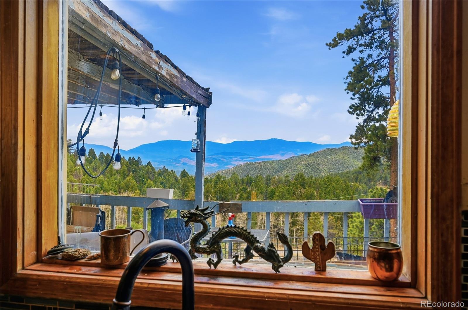 13108 Elsie Road Conifer, CO 80433 - Photo 7 of 49 a view of a balcony with lake view and a potted plant