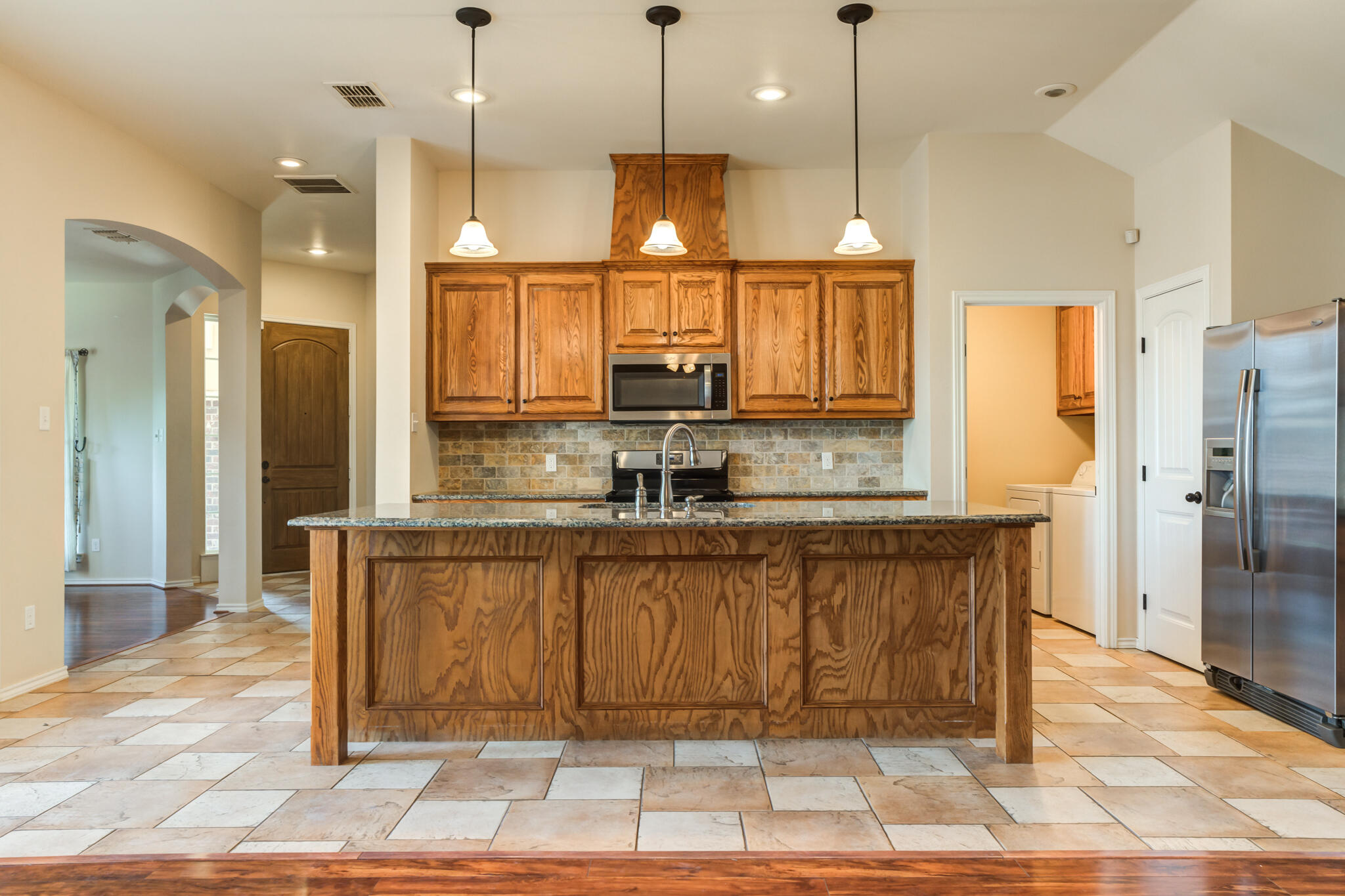 4802 Amherst Street Lubbock, TX 79416 - Photo 11 of 33 a view of a kitchen with a refrigerator a sink and a counter top space