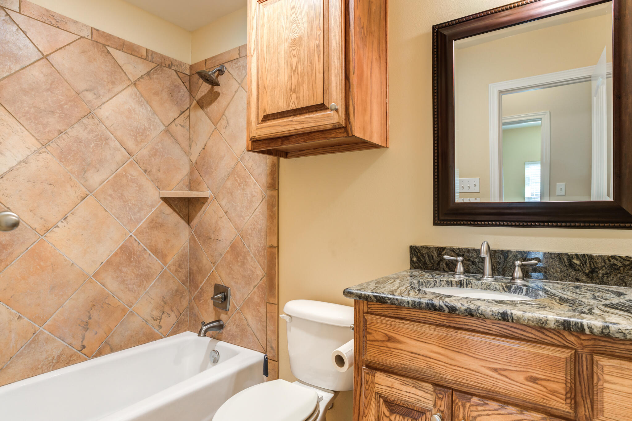 4802 Amherst Street Lubbock, TX 79416 - Photo 17 of 33 a bathroom with a granite countertop sink and a mirror