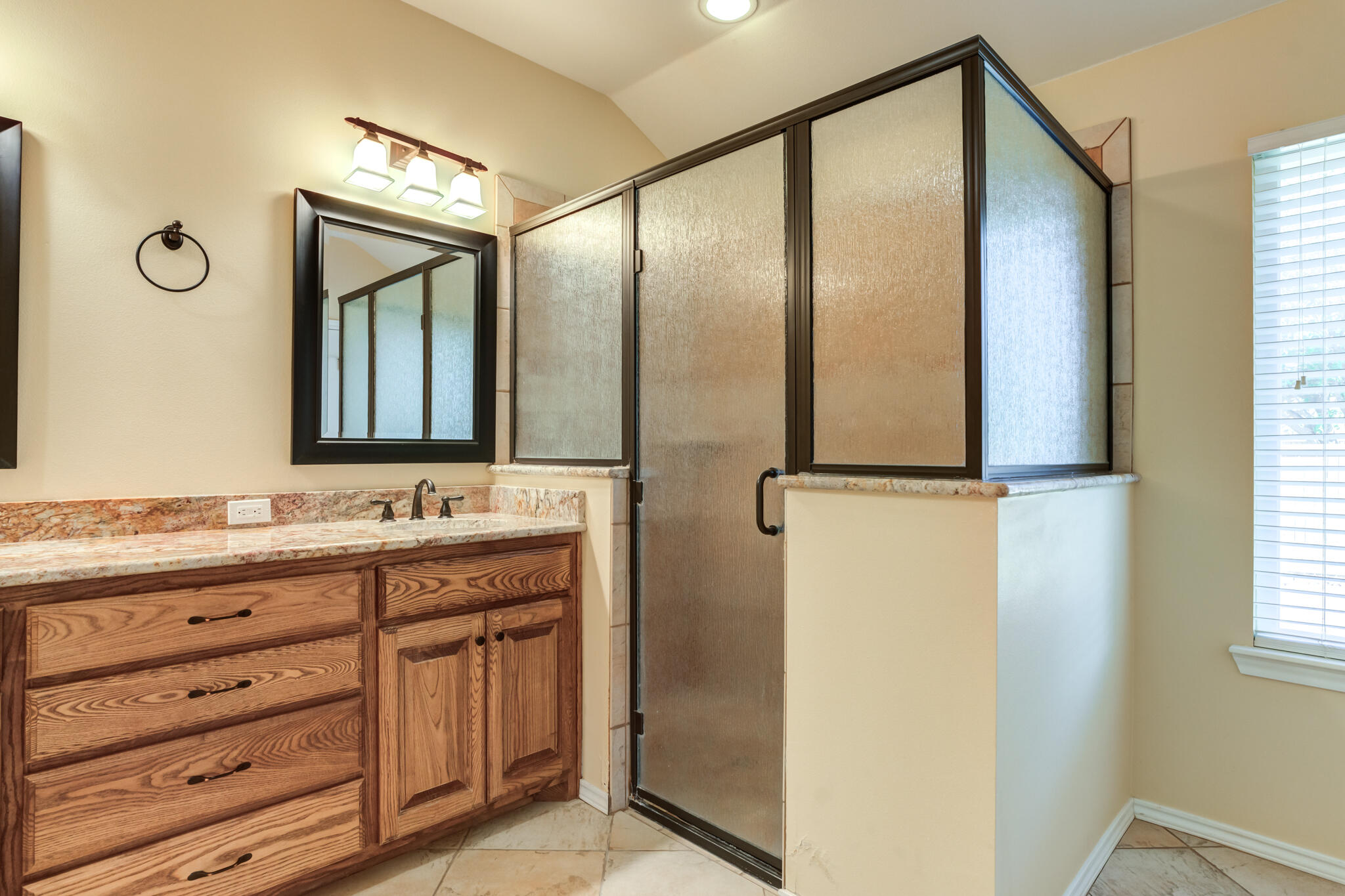 4802 Amherst Street Lubbock, TX 79416 - Photo 26 of 33 a bathroom with a granite countertop sink mirror and a