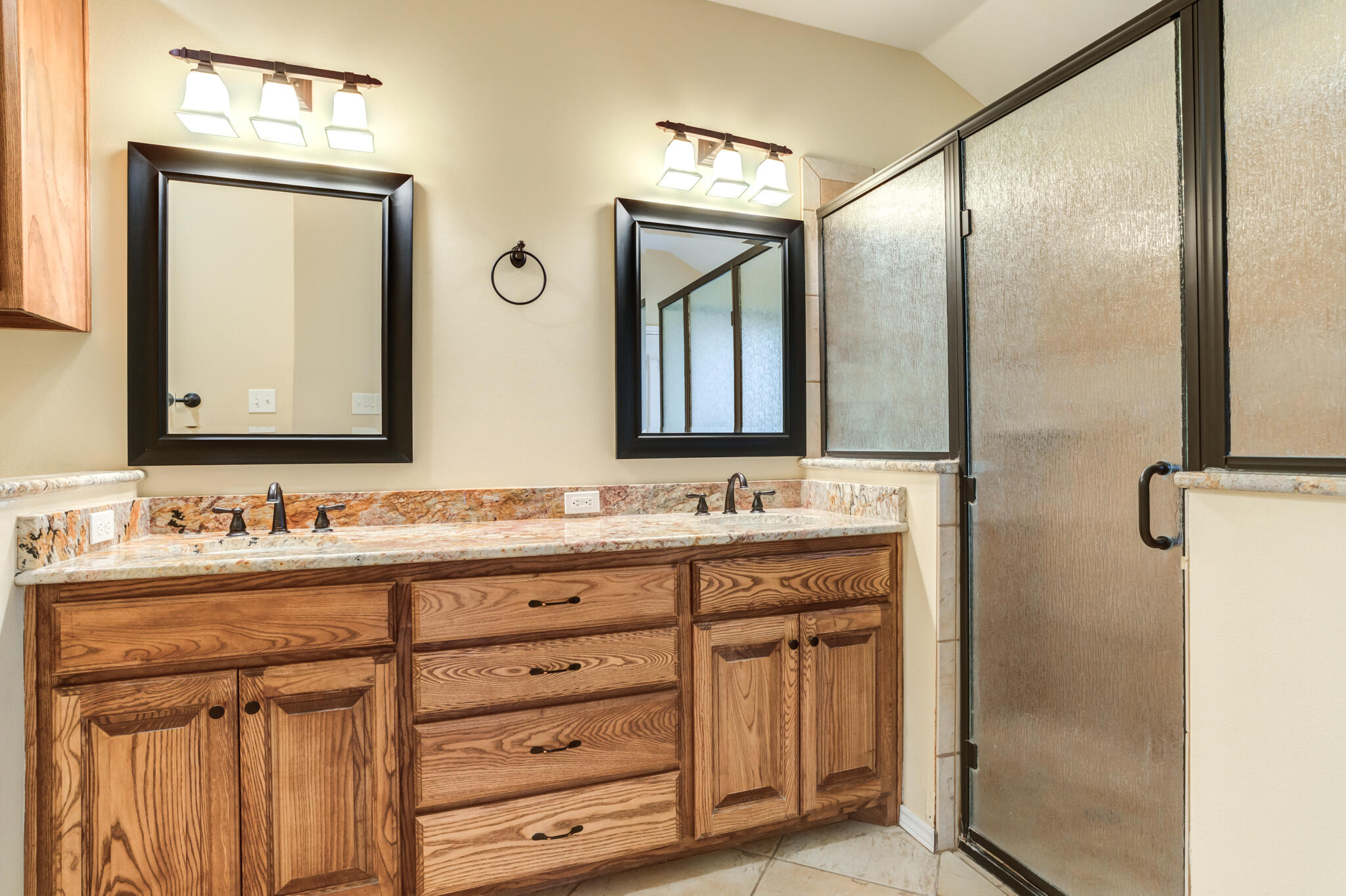 4802 Amherst Street Lubbock, TX 79416 - Photo 27 of 33 a bathroom with a double vanity sink and mirror