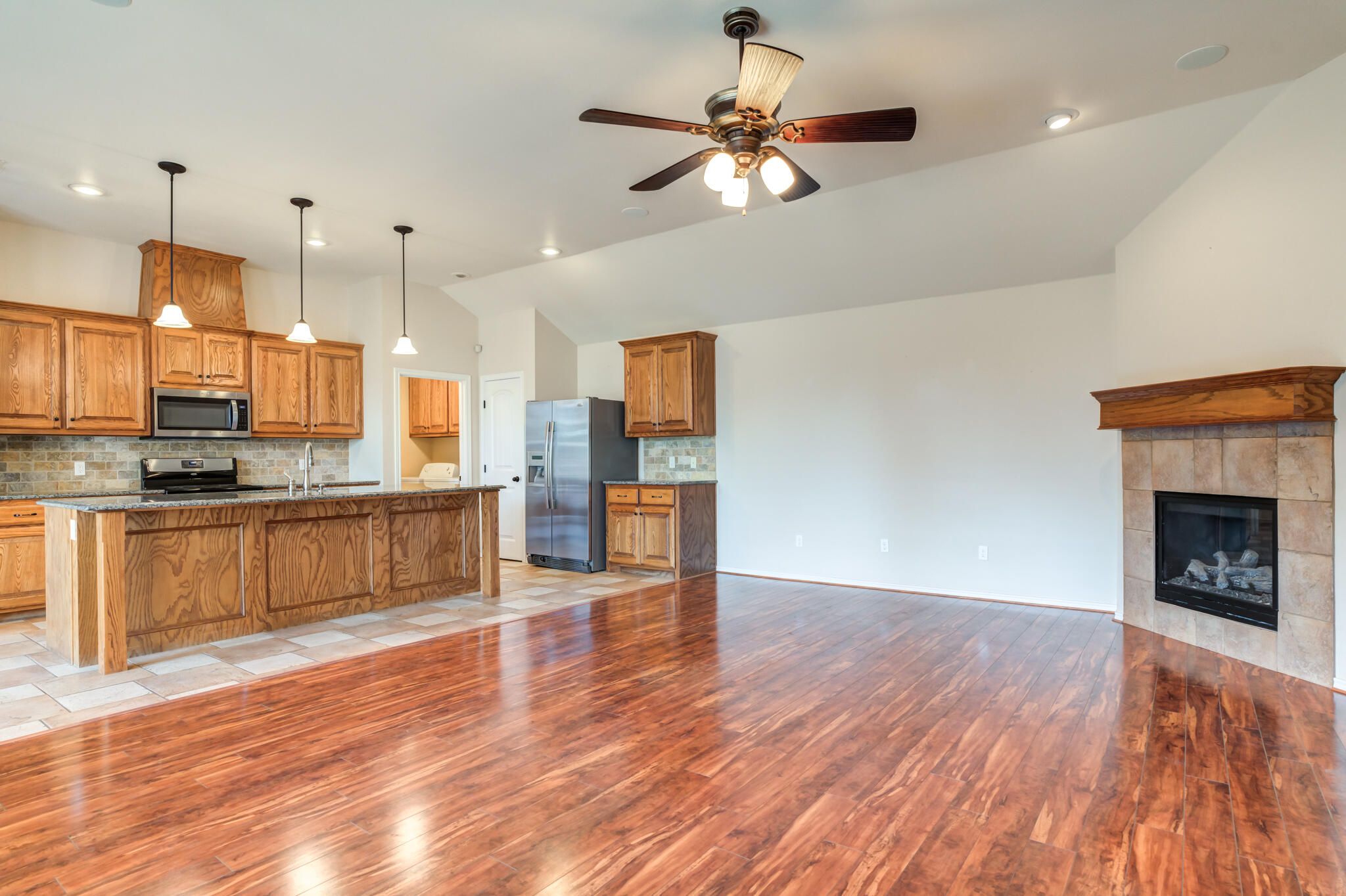 4802 Amherst Street Lubbock, TX 79416 - Photo 5 of 33 a view of kitchen with granite countertop stainless steel appliances and wooden floor