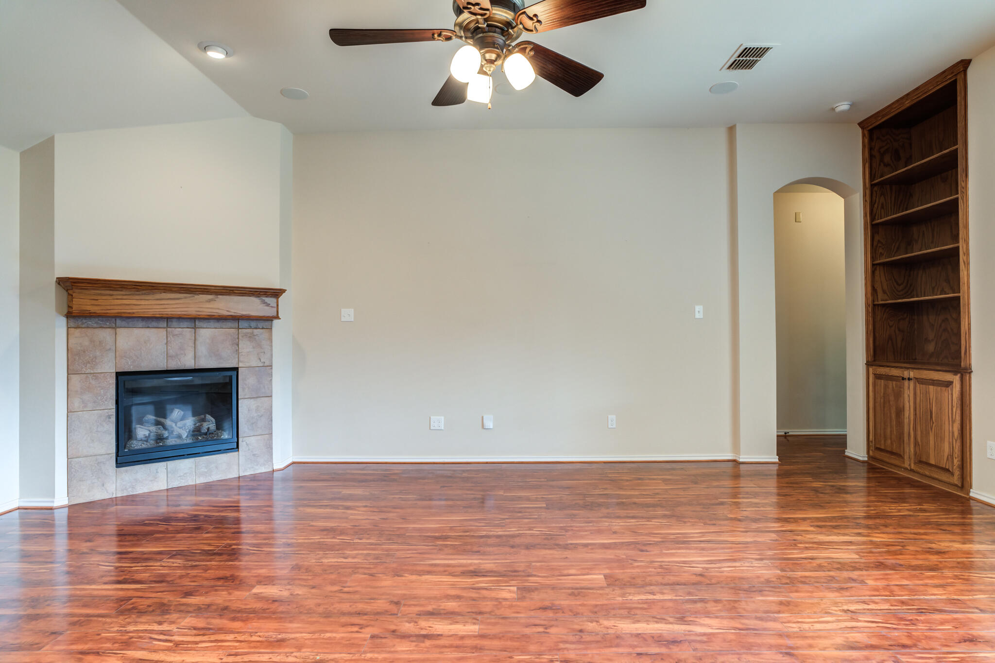 4802 Amherst Street Lubbock, TX 79416 - Photo 7 of 33 a view of empty room with wooden floor and fireplace