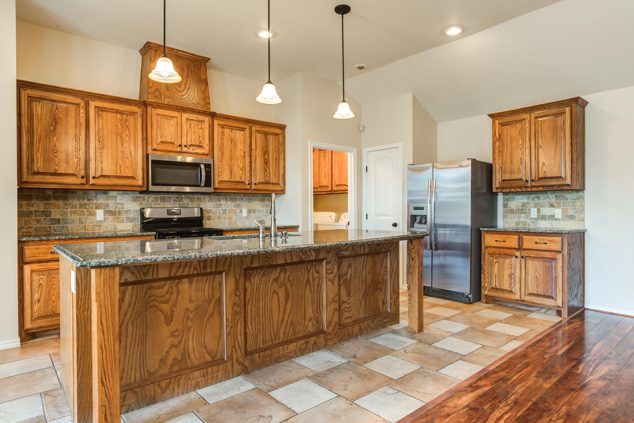 4802 Amherst Street Lubbock, TX 79416 - Photo 10 of 33 a kitchen with stainless steel appliances granite countertop a stove a sink and a refrigerator