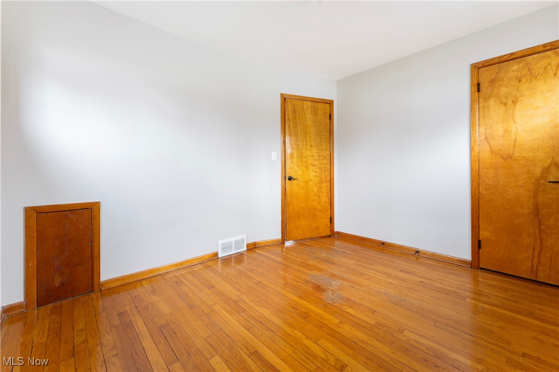 3105 Snow Road Cleveland, OH 44134 - Photo 17 of 38 Unfurnished room featuring light wood finished floors, baseboards, and visible vents