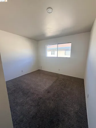 an empty room with a empty space and windows