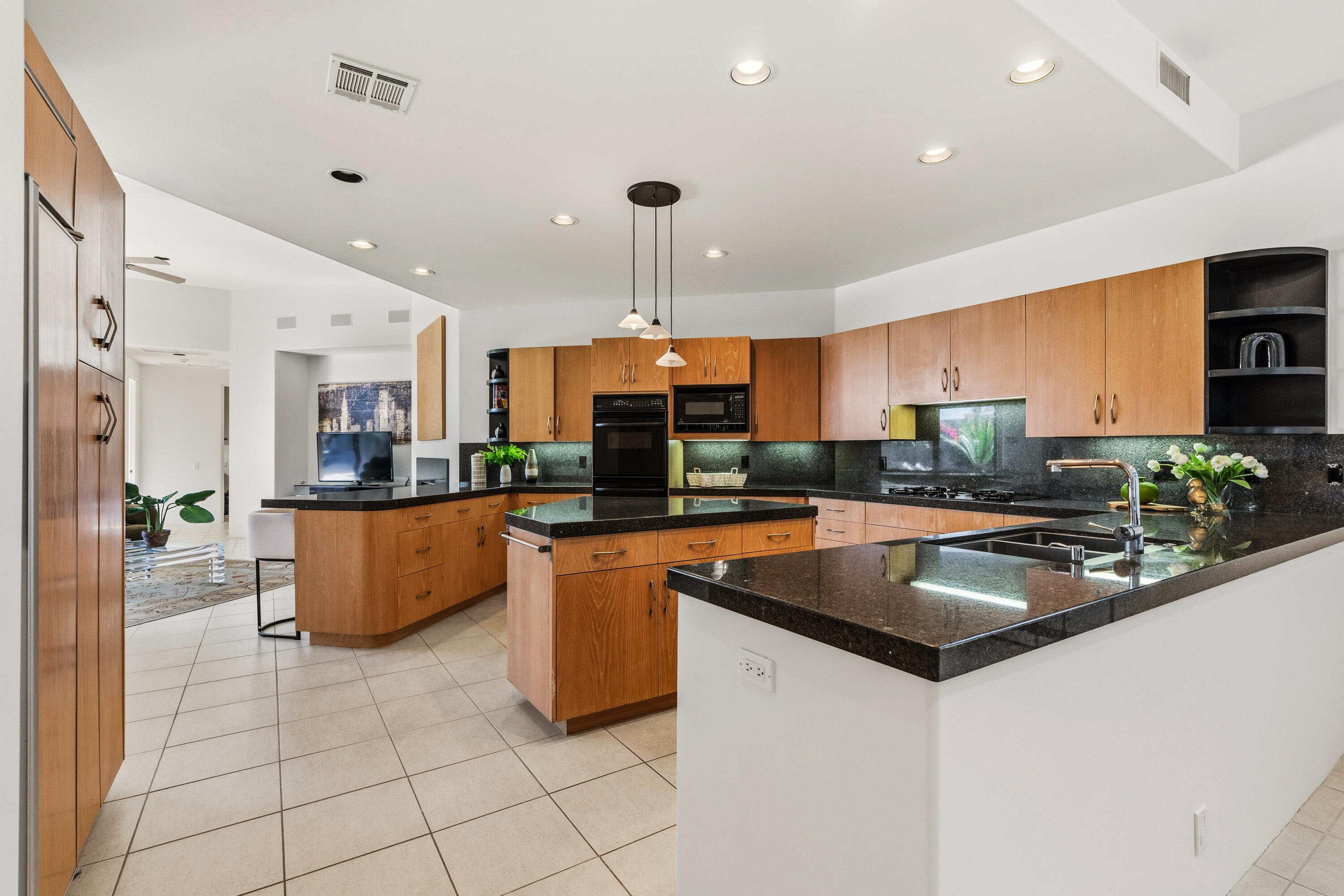 50120 Indian Camp Road La Quinta, CA 92253 - Photo 11 of 28 a kitchen with stainless steel appliances granite countertop a sink a stove and a refrigerator
