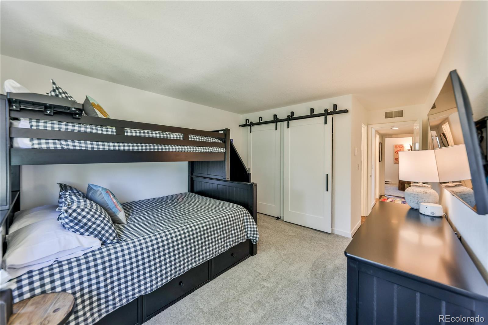 99 Doc Susie Avenue, Unit B6 Fraser, CO 80442 - Photo 16 of 25 a bedroom with a bed and a window