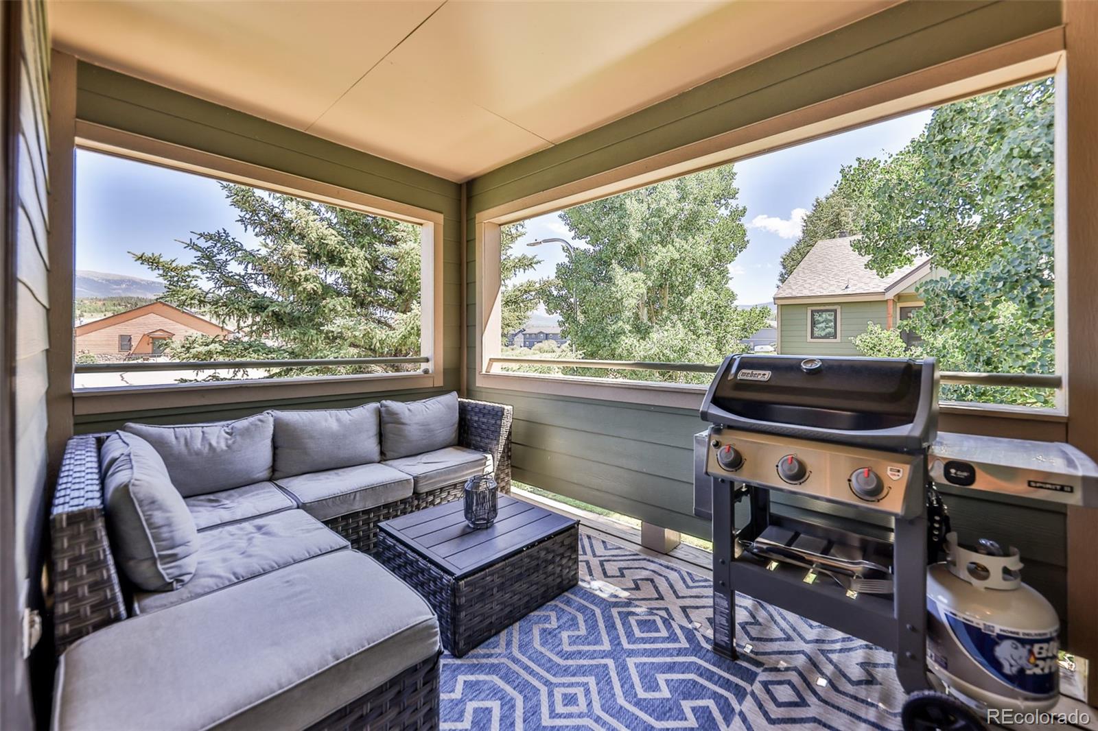 99 Doc Susie Avenue, Unit B6 Fraser, CO 80442 - Photo 21 of 25 a living room with furniture and a floor to ceiling window