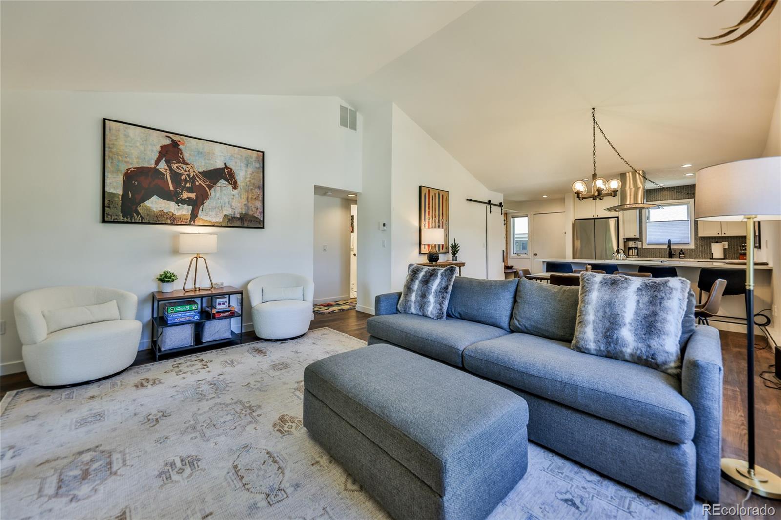 99 Doc Susie Avenue, Unit B6 Fraser, CO 80442 - Photo 5 of 25 a living room with furniture and a chandelier