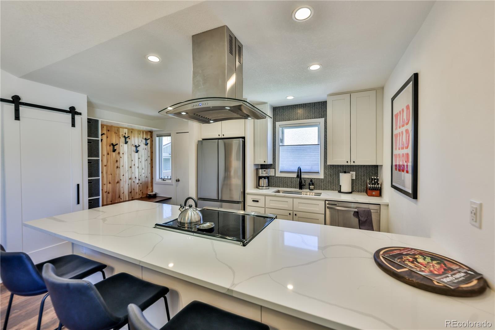 99 Doc Susie Avenue, Unit B6 Fraser, CO 80442 - Photo 10 of 25 a kitchen with a table chairs stove and refrigerator