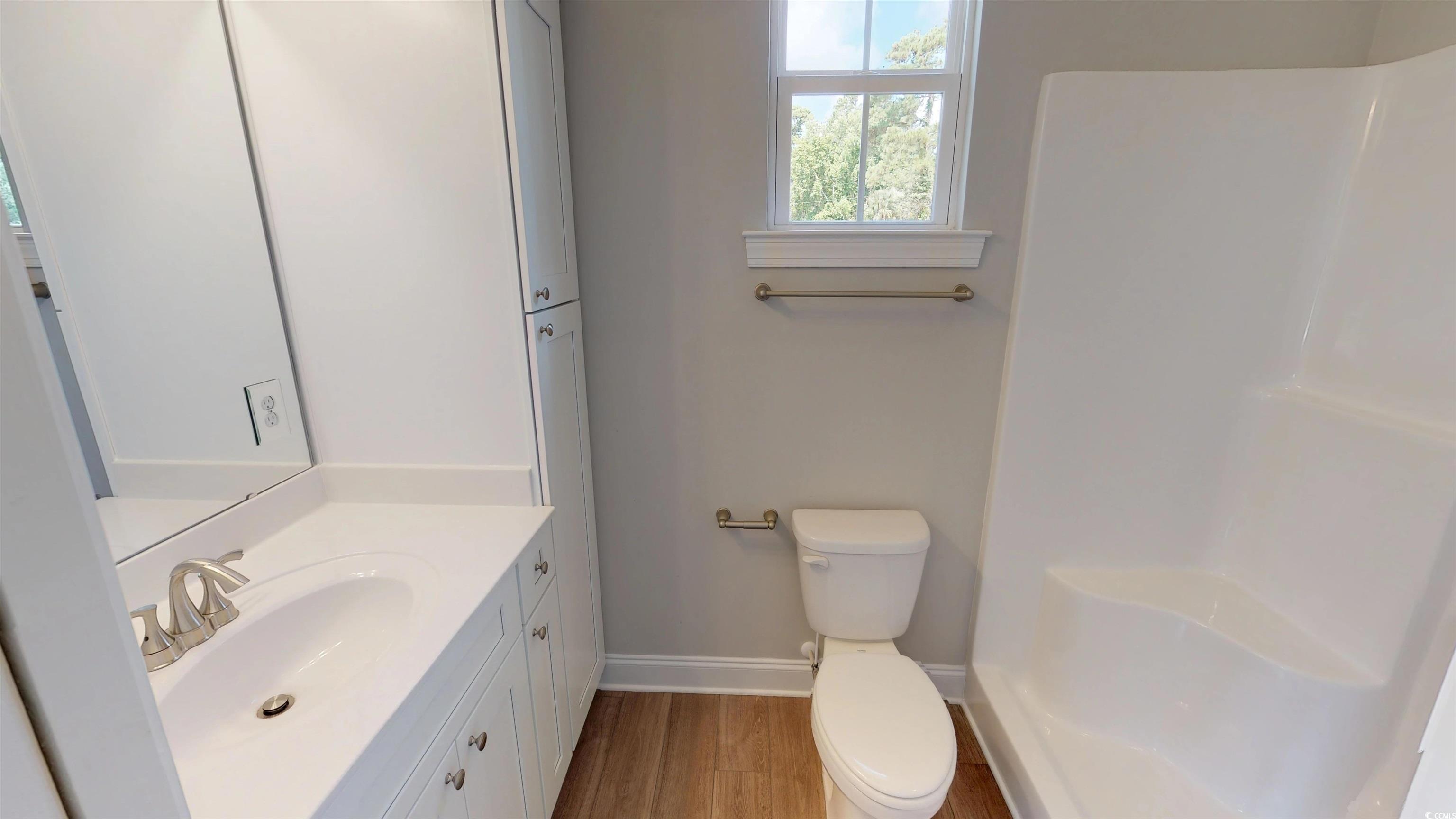 29 Wimbledon Court, Unit WVC 8 Pawleys Island, SC 29585 - Photo 12 of 12 Full bathroom with vanity, light wood-style flooring, and a shower