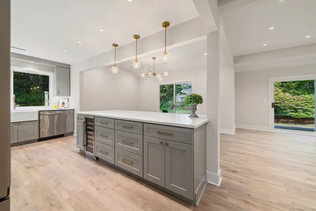 a large bathroom with a large mirror vanity and a shower