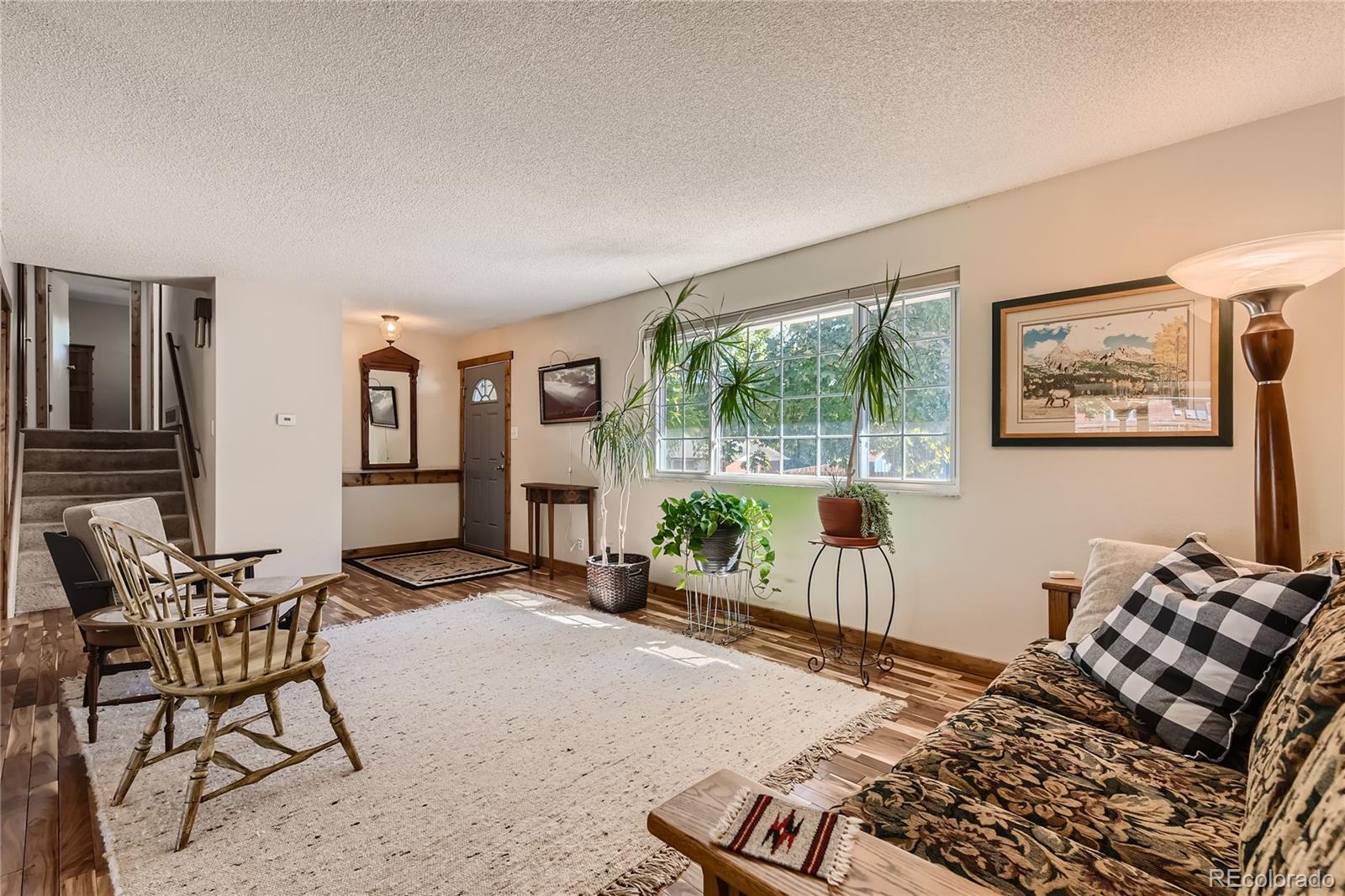10471 Romblon Way Northglenn, CO 80234 - Photo 2 of 11 a bedroom with furniture and a large window