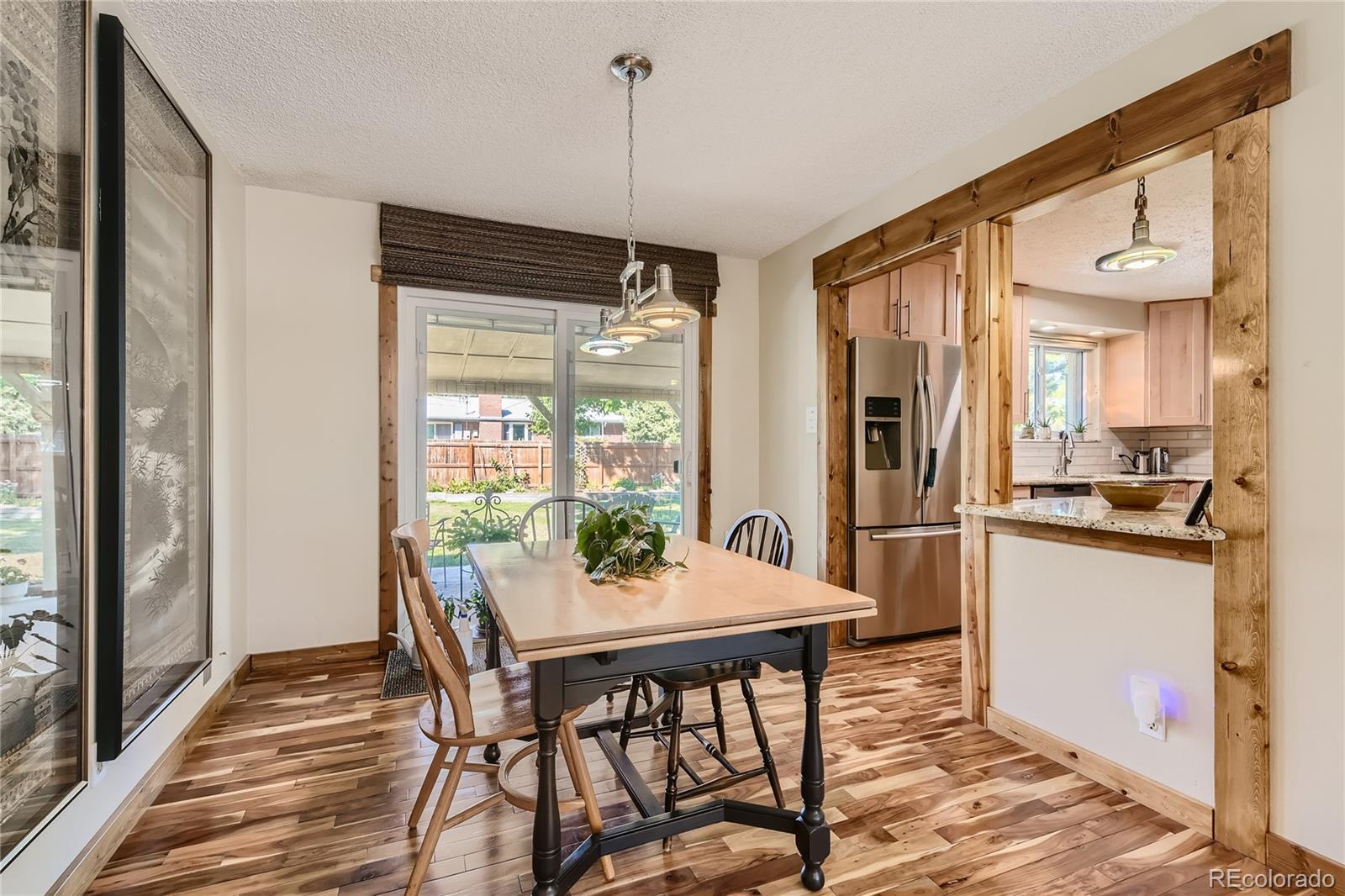 10471 Romblon Way Northglenn, CO 80234 - Photo 3 of 11 a view of a dining room with furniture window and wooden floor