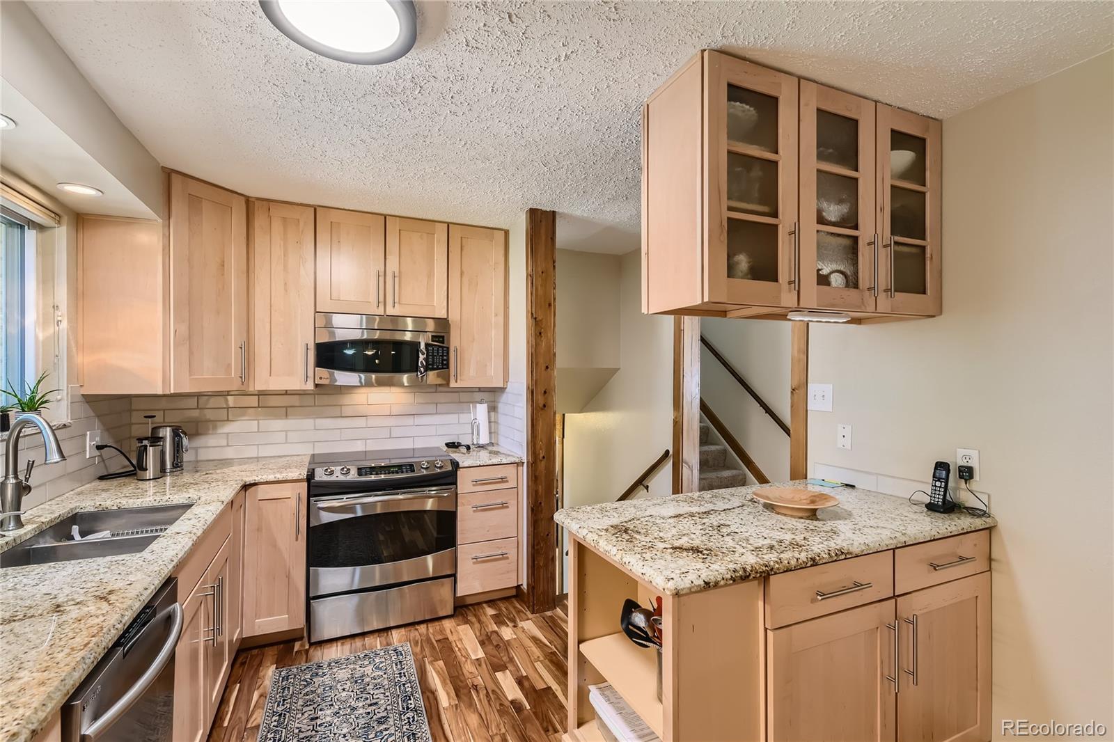 10471 Romblon Way Northglenn, CO 80234 - Photo 4 of 11 a kitchen with stainless steel appliances granite countertop a stove and a sink