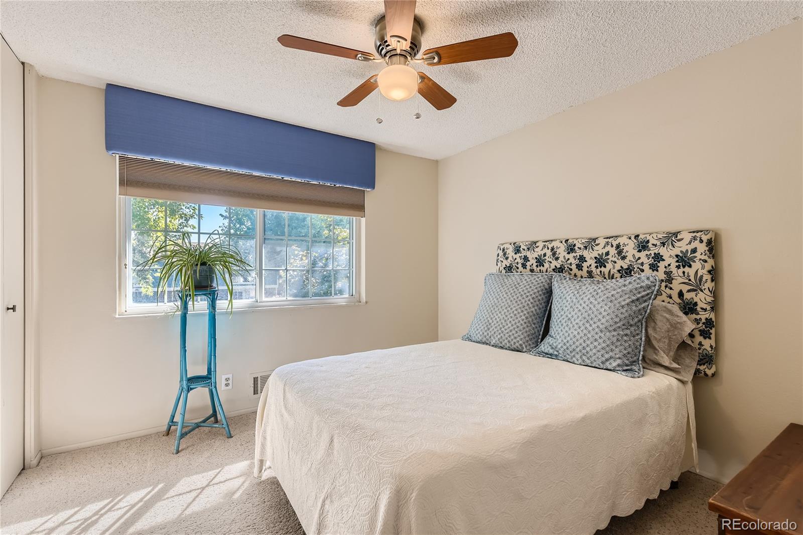 10471 Romblon Way Northglenn, CO 80234 - Photo 7 of 11 a bedroom with a large bed and a chandelier
