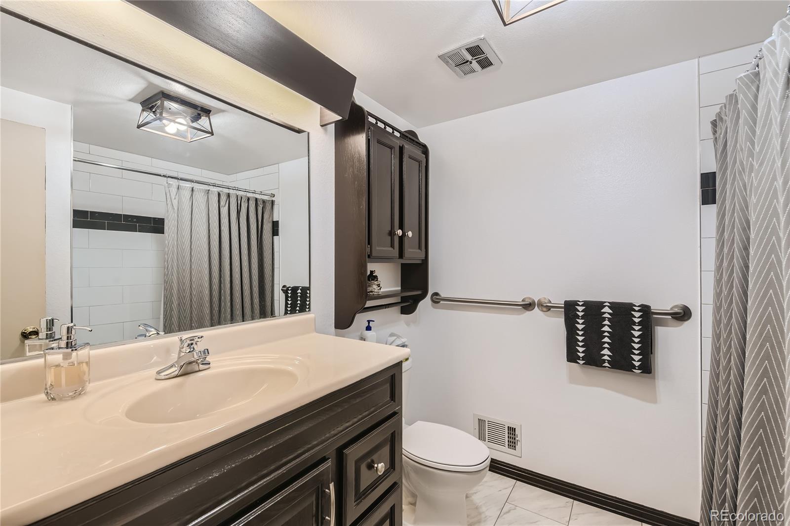 10471 Romblon Way Northglenn, CO 80234 - Photo 8 of 11 a bathroom with a sink and a mirror