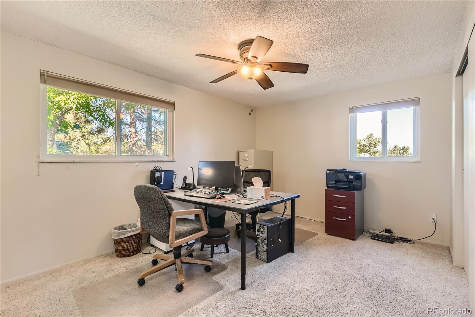 10471 Romblon Way Northglenn, CO 80234 - Photo 9 of 11 a view of a workspace with furniture and a window