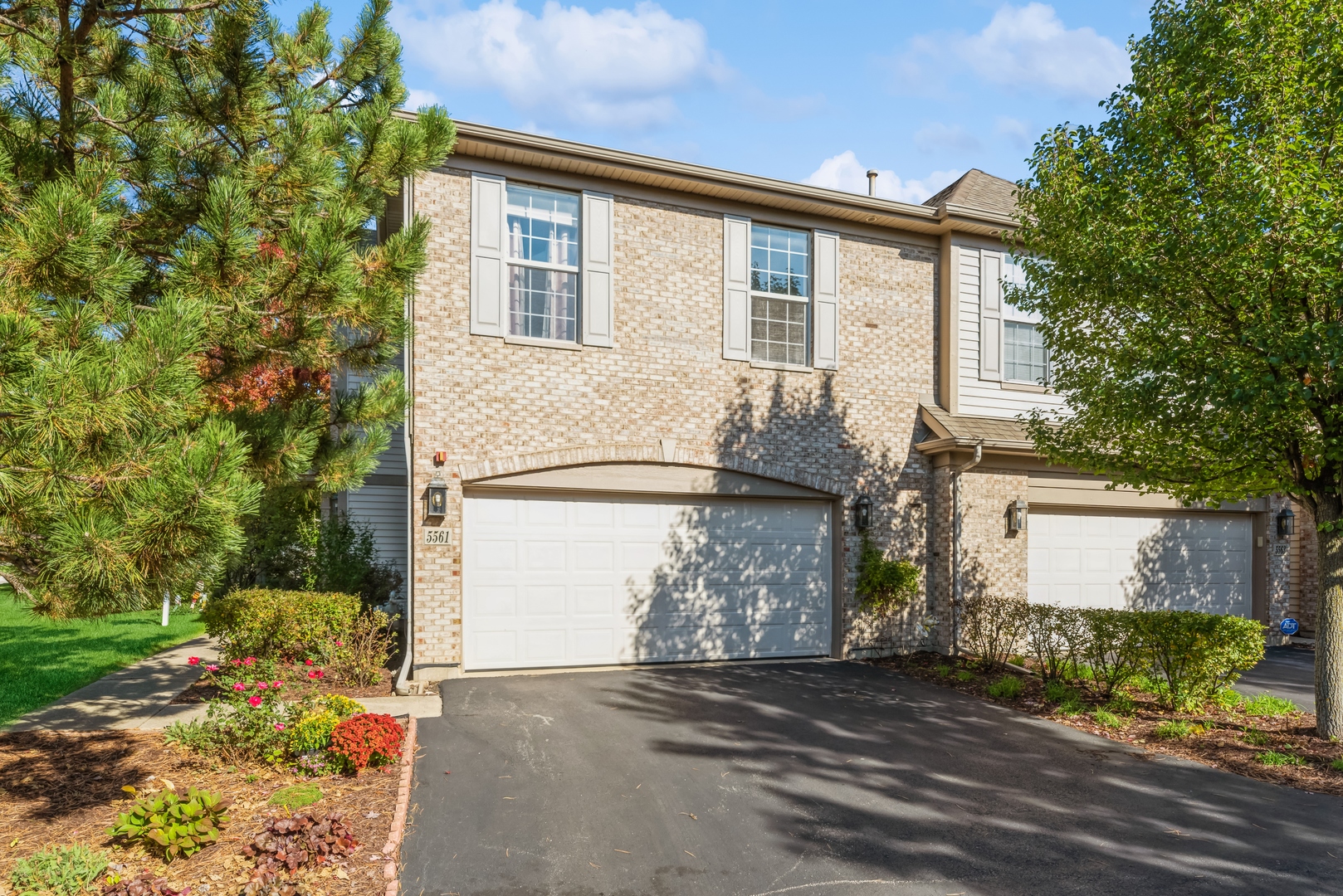 5561 McDonough Road Hoffman Estates, IL 60192 - Photo 15 of 16 a front view of a house with a yard and garage