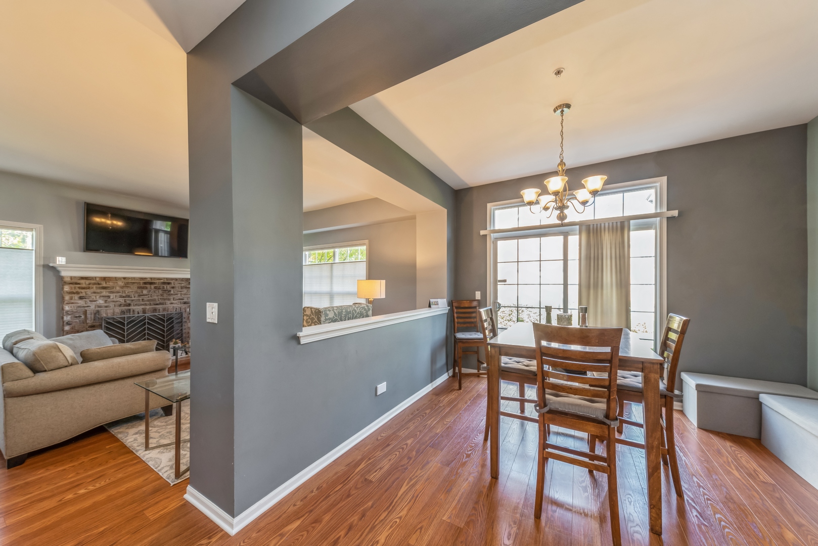 5561 McDonough Road Hoffman Estates, IL 60192 - Photo 3 of 16 a view of a dining room with furniture wooden floor and chandelier