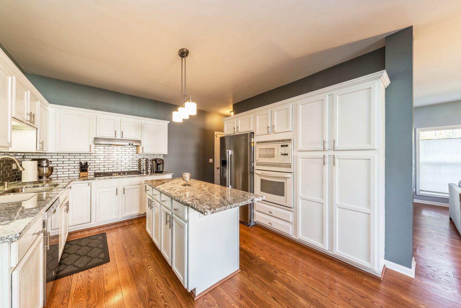 5561 McDonough Road Hoffman Estates, IL 60192 - Photo 5 of 16 a kitchen with granite countertop white cabinets and white appliances