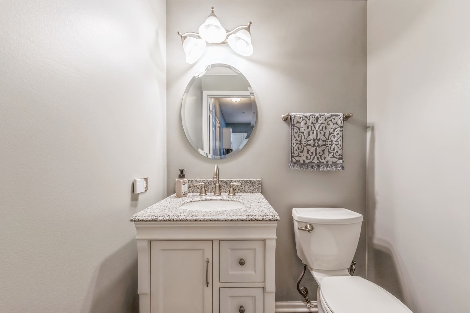 5561 McDonough Road Hoffman Estates, IL 60192 - Photo 6 of 16 a bathroom with a toilet sink and mirror