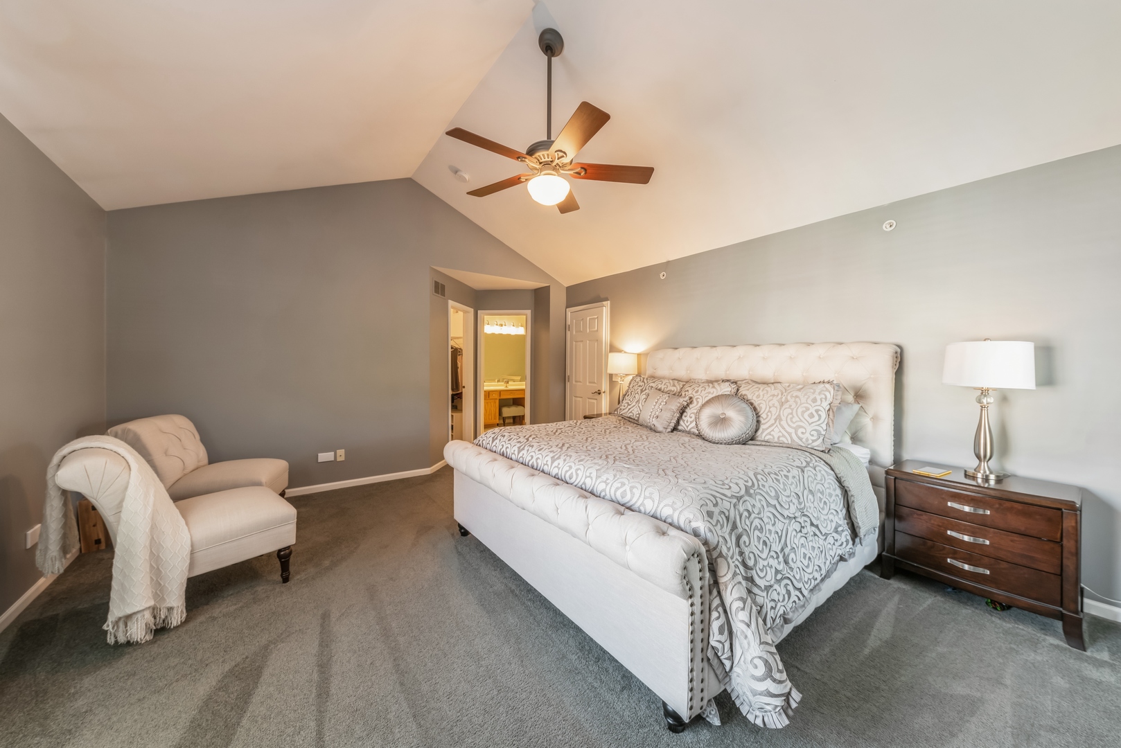 5561 McDonough Road Hoffman Estates, IL 60192 - Photo 8 of 16 a bedroom with a bed and a chandelier