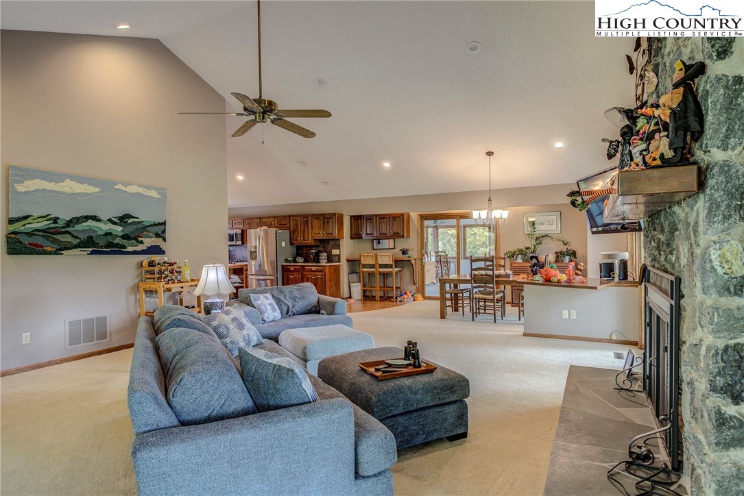 249 Red Bird Lane Glade Valley, NC 28627 - Photo 17 of 41 a living room with furniture and a chandelier
