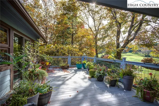 a view of a chair and tables on the wooden deck