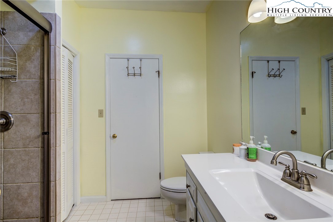 249 Red Bird Lane Glade Valley, NC 28627 - Photo 7 of 41 a bathroom with a sink a toilet and shower